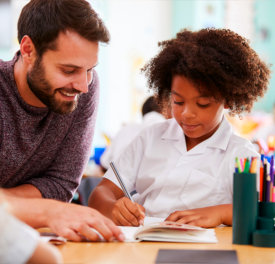 man and kid holding a pen