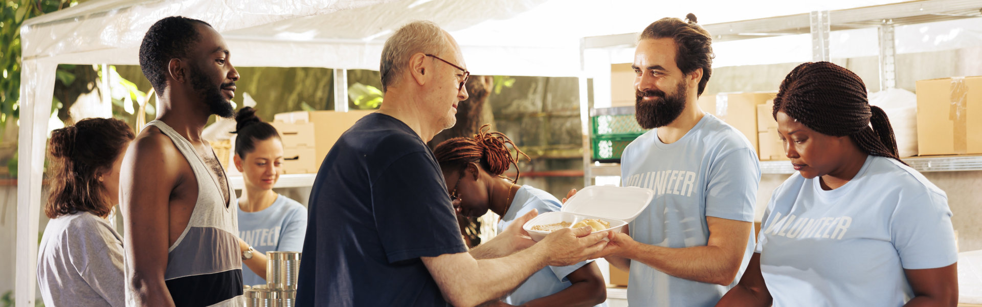 man giving food to senior